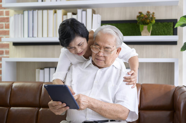 Older adult couple using iPad